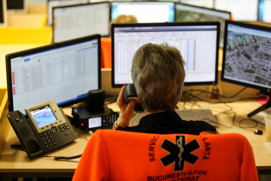 Shallow depth of field (selective focus) image with 112 emergency number operator (Romanian version of 911) having a conversation with a distress caller