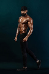 Fototapeta na wymiar Strong and fit man bodybuilder. Sporty muscular guy athlete. Sport and fitness concept. Men's fashion.
