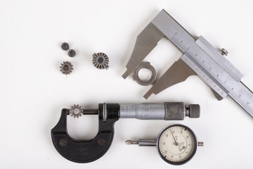Micrometer, caliper and gear wheels for measurements. Workshop accessories.