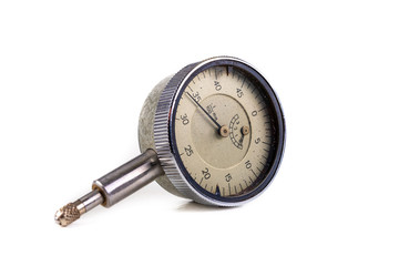 Dial indicator on a white table. Measuring tools used in the workshop.