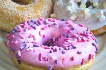 Sweet colorful dessert. Donut with a hole and pink delicious icing.