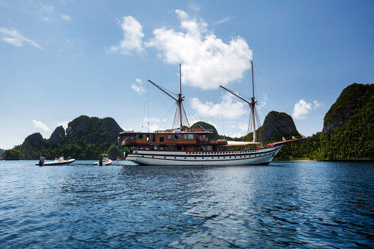 Sail boat between islands of remote archipelago Pulau Wayag, Raja Ampat, Indonesia