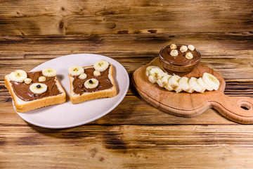 Two sandwiches with chocolate spread on a plate. Sandwich like a bear muzzle