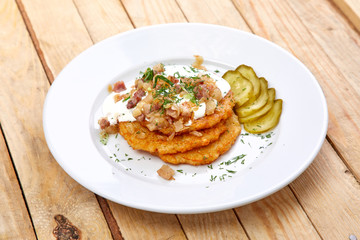 potato pancakes with bacon and sour cream