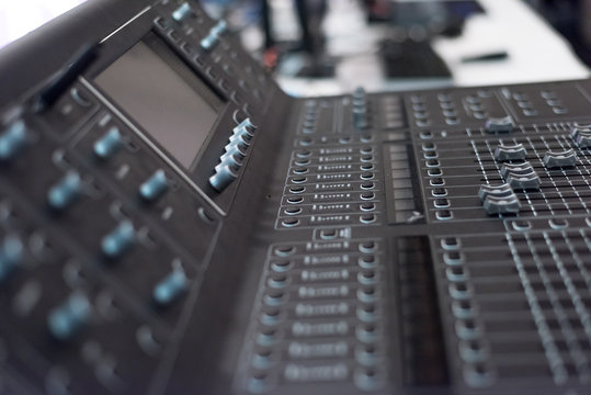 Audio sound mixer console. Audio mixer, music equipment. broadcasting tools, mixer, synthesizer. and computer control.Professional sound and audio mixer control panel with buttons and sliders.