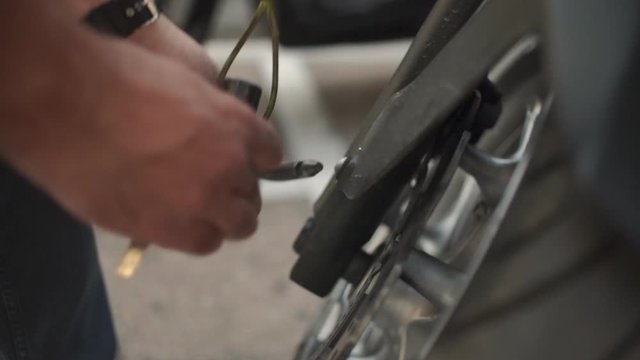 Close up of motorcyclist removing a lock from his motorcycle