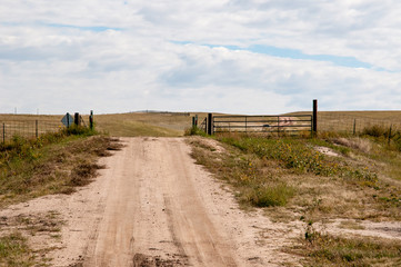 Driving on a dirt road under a cloudy sky