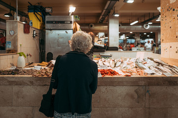 CAGLIARI, ITALY / OCTOBER 2019: Fish vendors at the San Benedetto food market