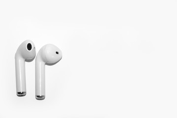 A pair of modern wireless headphones on a white background, space for lettering.