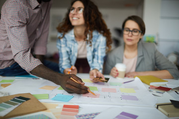Creative business team working on design project focus on table with roadmap and colorful stickie notes, copy space
