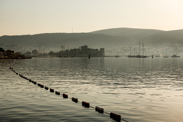 Panoramic Sunrise view of Bodrum Castle and marina bay on Turkish Riviera from old wooden docks. Bodrum is a district and a port city in Mugla Province, in Aegean Region of Turkey