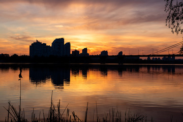 Fototapeta na wymiar background. residential complex. Beautiful sunset / dawn and reflection in the river. Kiev, Ukraine