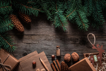 Christmas green frame from fir branches on a vintage gray board background. Frame of fir branches. Christmas card blank.
