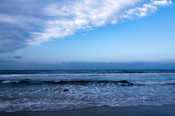 Blue sea water waves and sandy beach