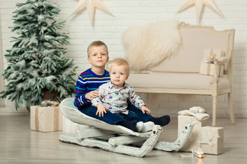 Christmas is already here. Two brothers sledding with christmas gift box. Small cute boy received holiday gifts. Kid hold gift box while sledding. Celebrate christmas. Winter activity