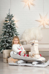 Christmas is already here. Girl sledding with christmas gift box. Small cute girl received holiday gifts. Kid hold gift box while sledding. Celebrate christmas. Winter activity