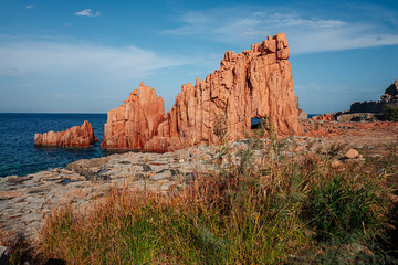 ARBATAX, ITALY / OCTOBER 2019: The scenic red rocks beach in Sardinia, Ogliastra region