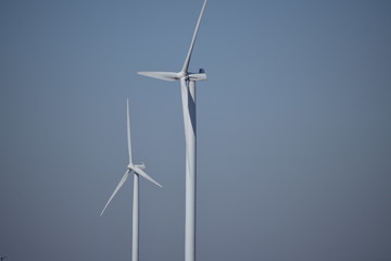 Fototapeta premium closeup of wind turbine against blue sky