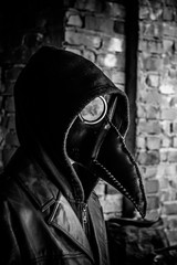 Terrible plague doctor, black and white. Masked maniac. Halloween and horror concept