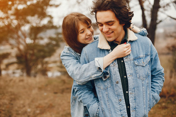 Fototapeta premium gentle and stylish couple are having a walk in the autumn park