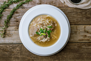 lamb noodle soup on wooden table