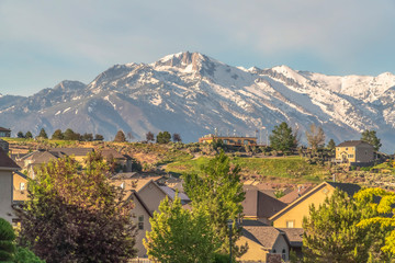 Family homes at a neighborhood with view of a snow covered mountain against sky