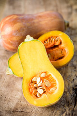 Half butternut squash on wooden background