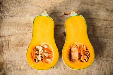 Half butternut squash on wooden background, top view