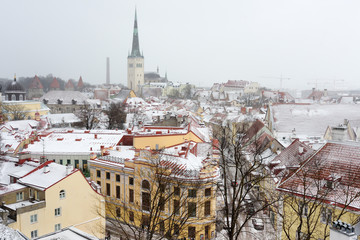 Fototapeta na wymiar Aerial cityscape view of Tallinn Old Medieval Town on winter day. St. Olaf's Church spire visible in the distance.