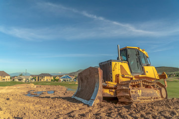 Obraz na płótnie Canvas Bulldozer at a construction site with copy space