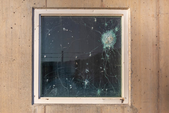 Bullet holes in the window glass of a bulletproof bunker