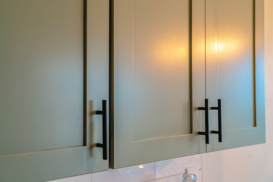 Close up of overhead kitchen cupboards at home