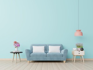 Blue wall living room with blue sofa.