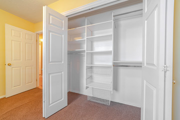 Empty white built in closet or wardrobe interior