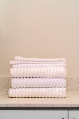 Fototapeta na wymiar Stack of clean white ribbed towels in a bathroom