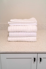Fototapeta na wymiar Set of neatly folded clean white ribbed towels