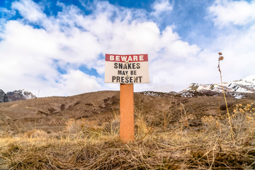 Warning sign - beware Snakes Might Be Present