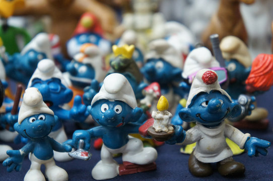KUALA LUMPUR, MALAYSIA -DECEMBER 9, 2018:  Selective focused of fictional cartoon action figure Smurfs in miniature model displayed for the public on a desk. 