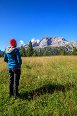 Fototapeta na wymiar hiker girl in the mountains relaxing and enjoying the view