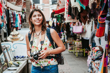 Latin woman backpacker shopping in a Tourist Market in Mexico City, Mexican Traveler in America
