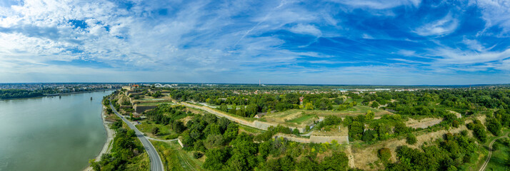 Aerial panorama view of Petrovaradin fortress trdava above the Danube River across from Novi Sad Serbia with lot of detail of the walls, ramparts and moats and blue sky