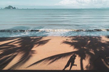 Shadow of young couple kissing at the tropical beach on summer vacation