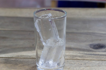 A glass of water on a wooden table