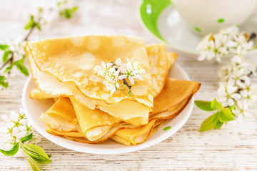 Pancakes, tea and flowers of cherry