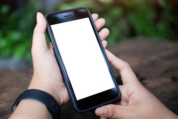 Mock up smartphone of man hands holding smart phone with blank copy space screen for your text message or information content, female reading text message on cell telephone during in urban setting.