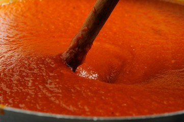 Fototapeta na wymiar Tomato Sauce, Tomato, Sauce, Cooking, Pan. Hot, Red. Italian Cuisine, Pizza Sauce,. wood Spoon