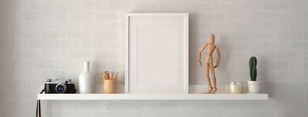 Mock up frame and decorations on shelf with white wall