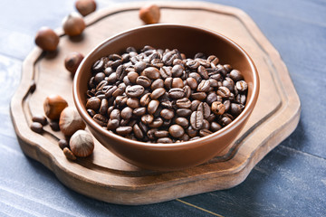 Bowl with coffee beans on table
