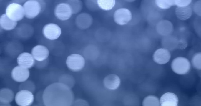 Glittering blue lights in blurry bokeh background