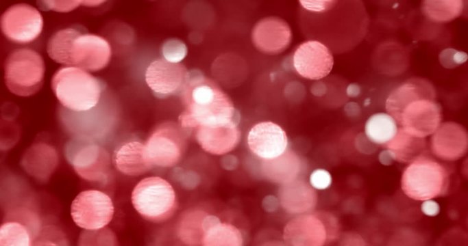 Christmas bokeh background. Glittering blurry white lights on red background